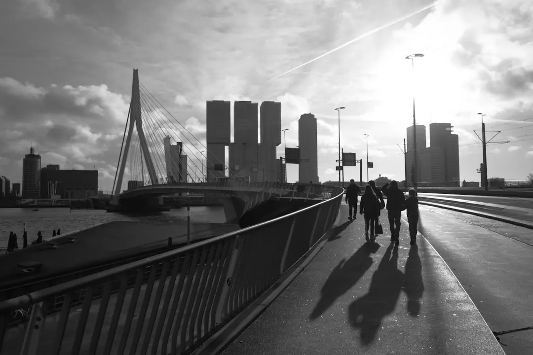 Mensen lopen over een brug in Rotterdam.